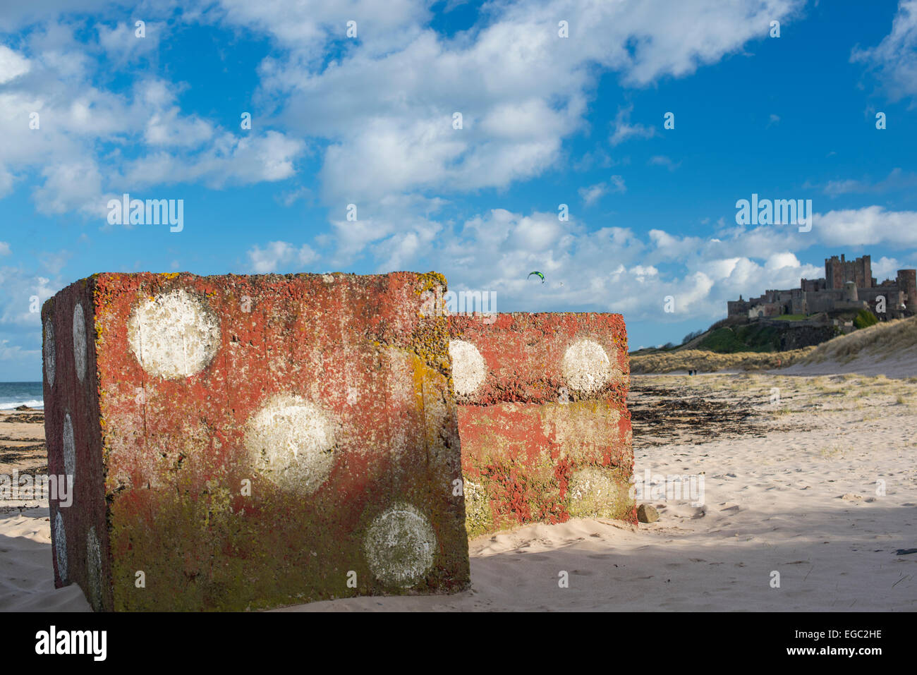 Dice  (painted on defences) on Bamburgh Beach with Castle in background, February  2015 Stock Photo