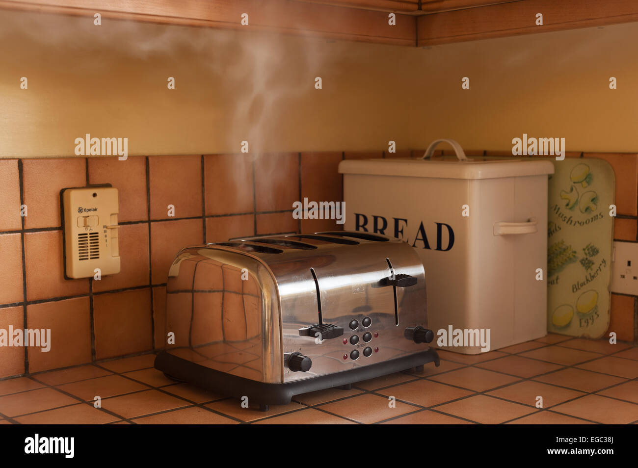 risk of fire smoking burning toast in the toaster in kitchen