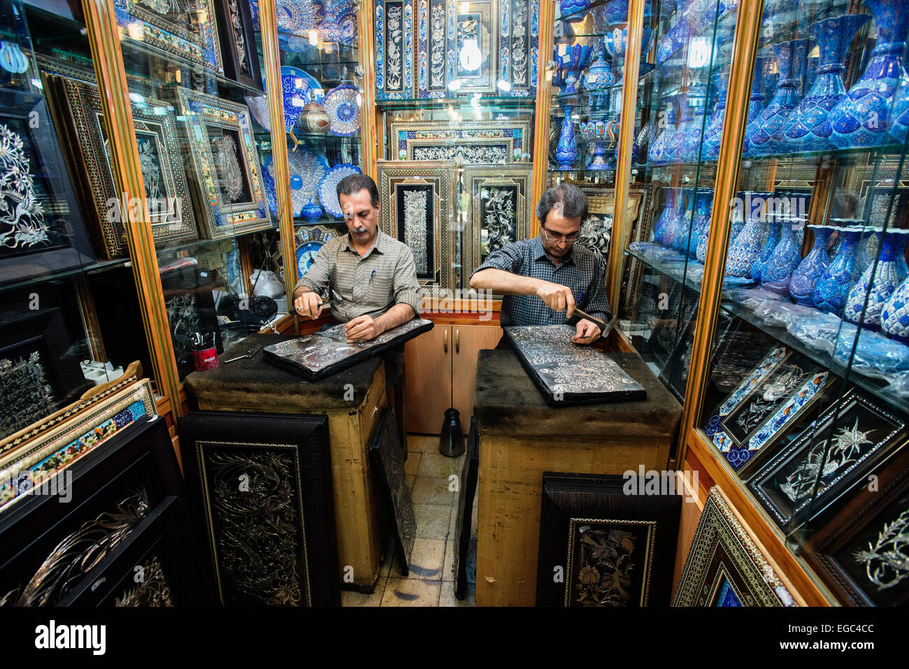 Artists emboss ghalamzani silver pieces, ghalamzani means art of embossing patterns on different metals such as copper, silver, gold, and brass, Esfahan, Iran Stock Photo