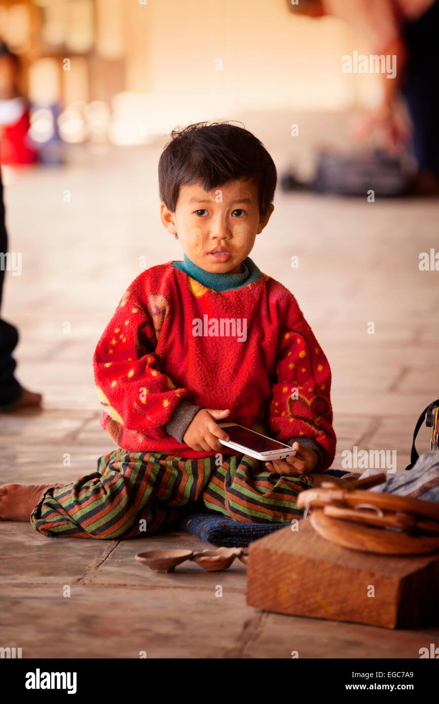 A young asian boy playing with a mobile phone, Bagan, Myanmar ( Burma ...