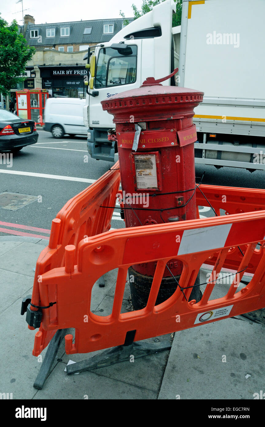 Closed Post Box damaged after being hit by vehicle, Holloway Road, London England Britain UK Stock Photo