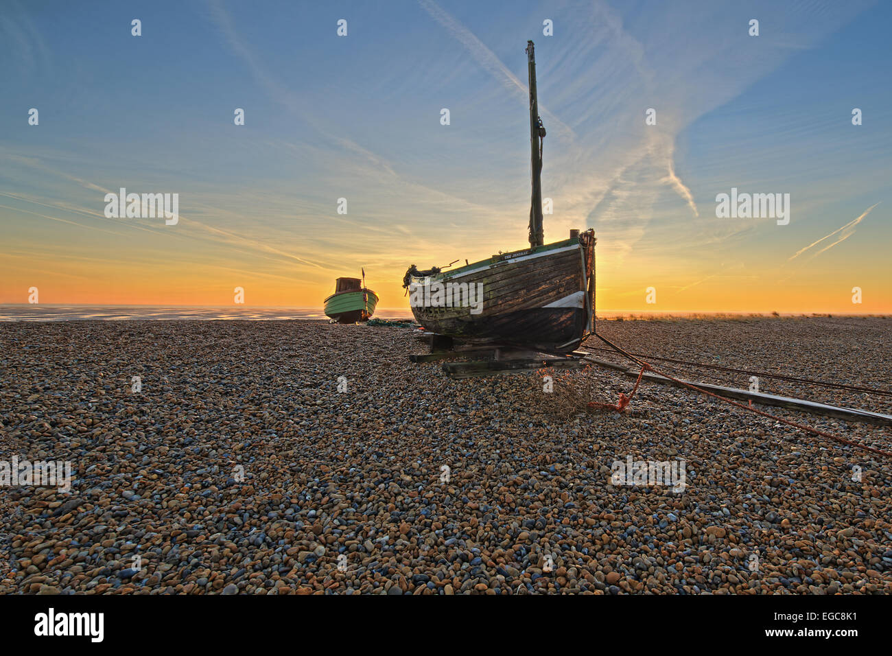 An image of an abandoned and wrecked boat on a shingle beach Stock Photo
