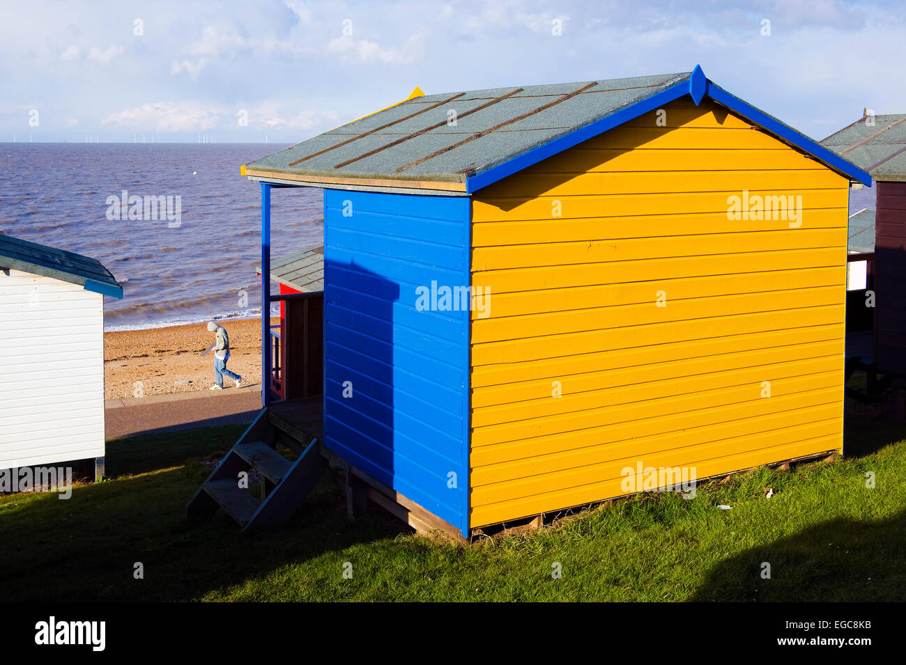 colourful wooden beach huts overlooking the sea at Tankerton near Whitstable Kent Stock Photo