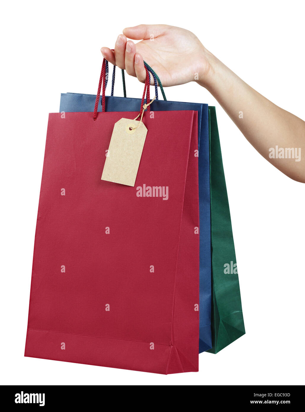 colorful bags with a price tag in a woman hand isolated on white with clipping paths Stock Photo