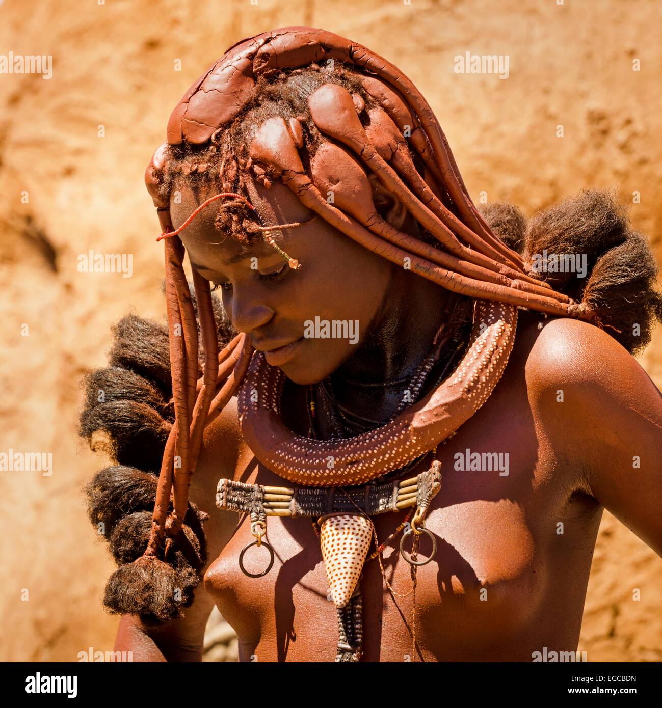 A young woman belonging to the indigenous Himba people pictured in her village in Kaokoland, Namibia, Africa. Stock Photo