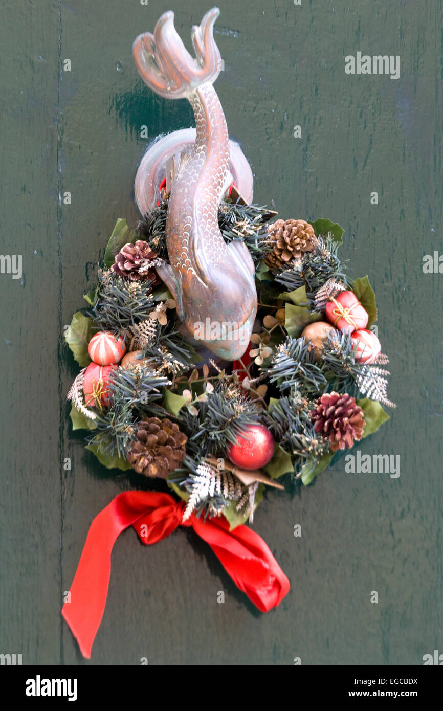 Bronze Koi Carp door Knocker and Christmas wreath decoration Stock Photo