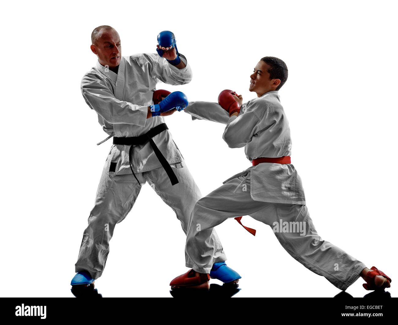 two karate men sensei and teenager student fighters fighting protections isolated on white background Stock Photo