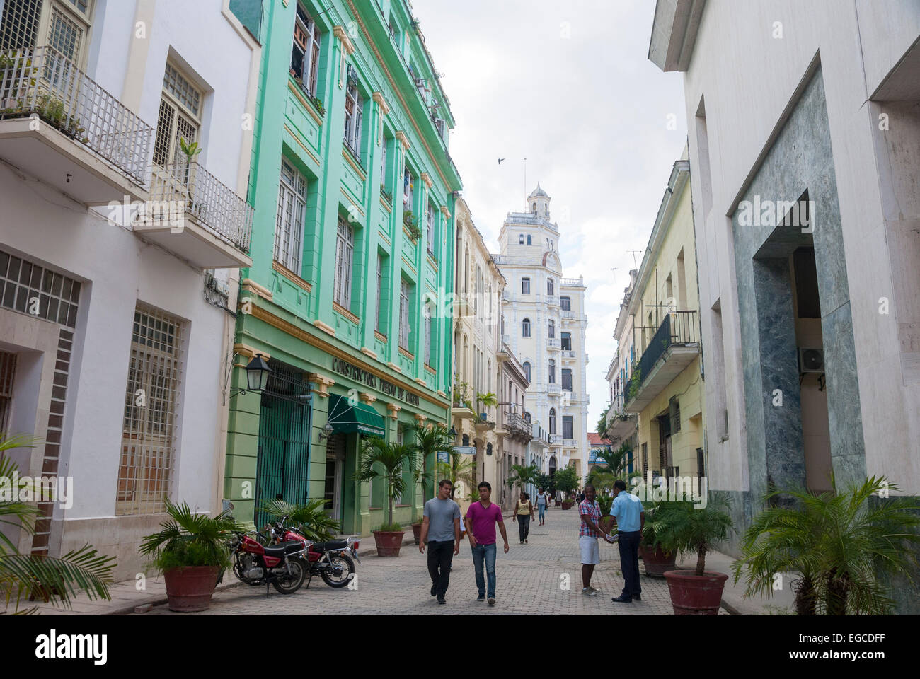 A downtown street scene in the old part of downtown Havana Cuba  with tourists and locals admiring the restored colonial buildings and narrow streets. Stock Photo