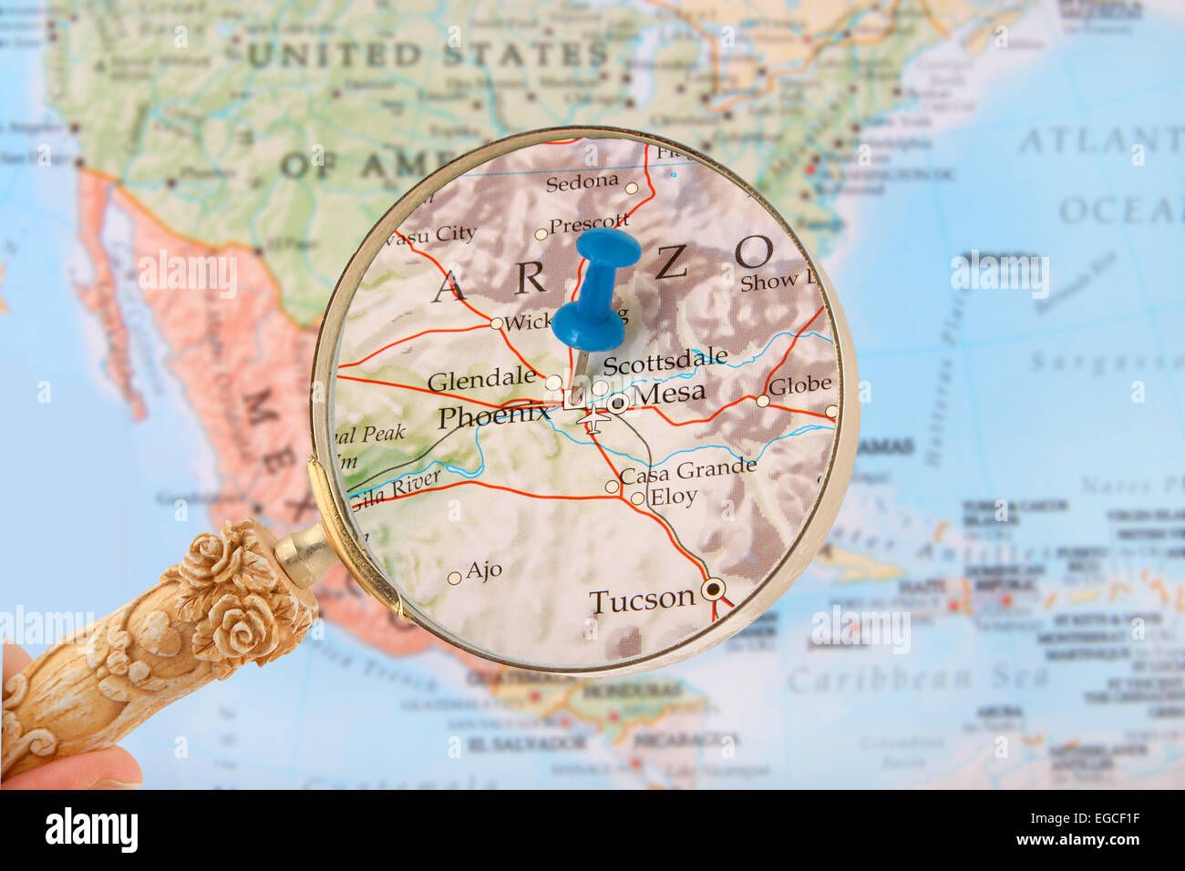 Blue tack on map of United States of America with magnifying glass