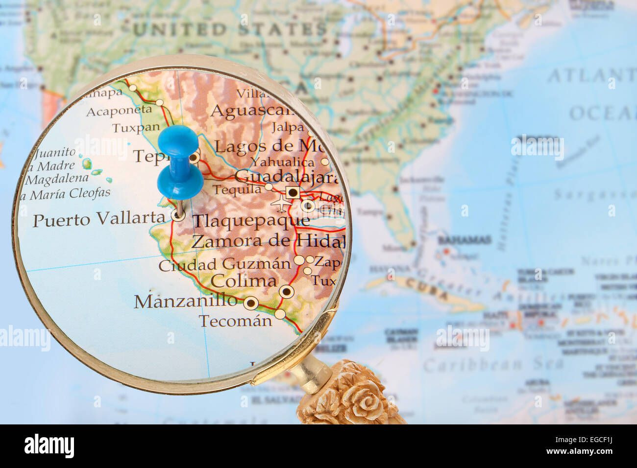 Blue tack on map of North America with magnifying glass looking in on