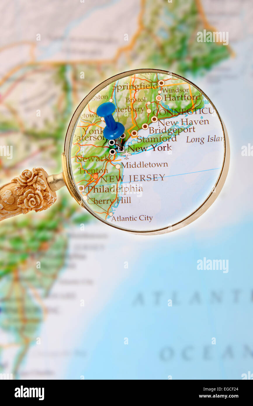 Blue tack on map of Eastern USA with magnifying glass looking in on New