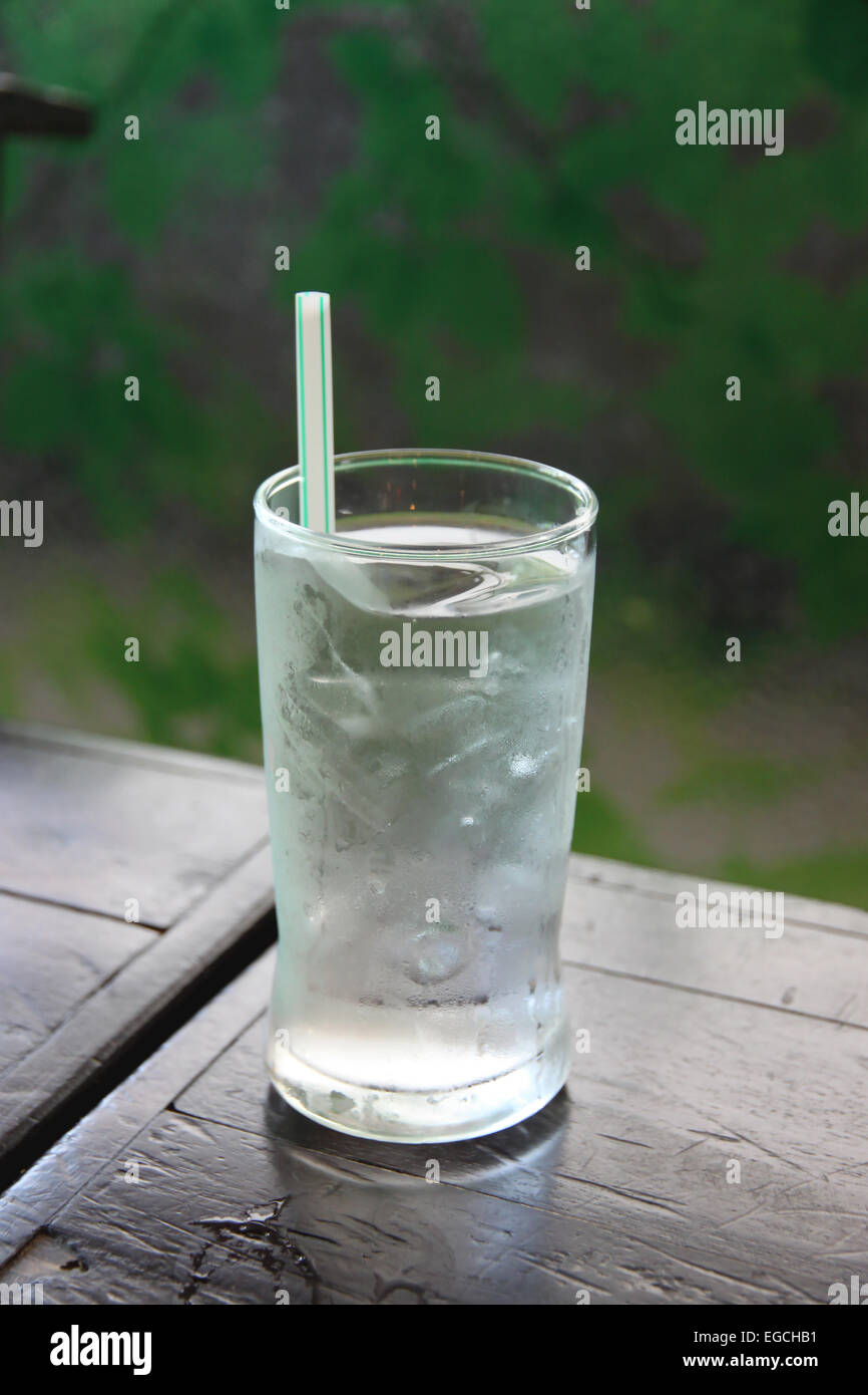 The glass on wood table with ice and water. Stock Photo