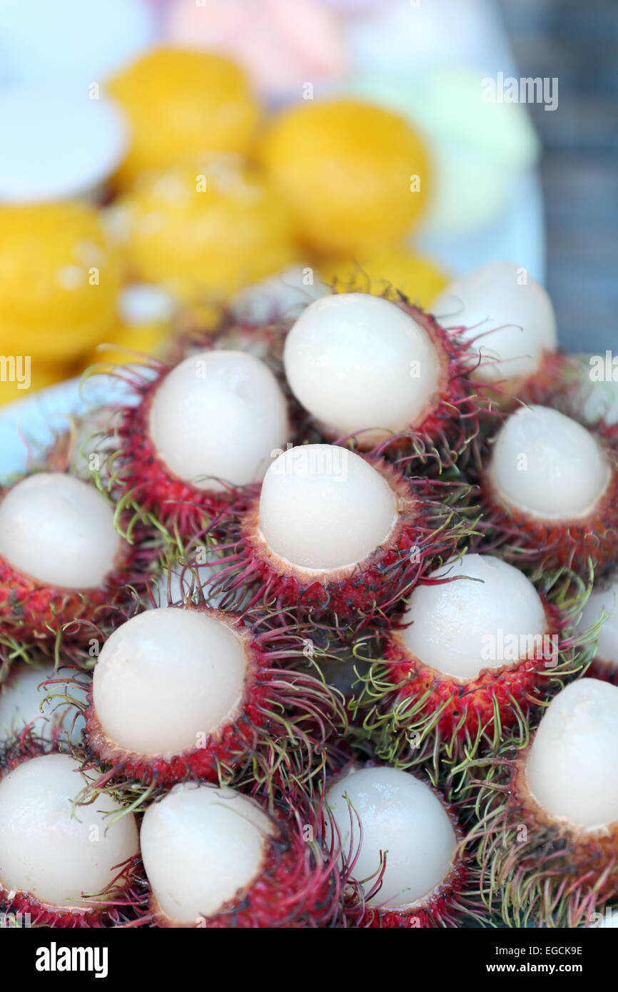 Rambutan fruit is peeled in dish. Stock Photo