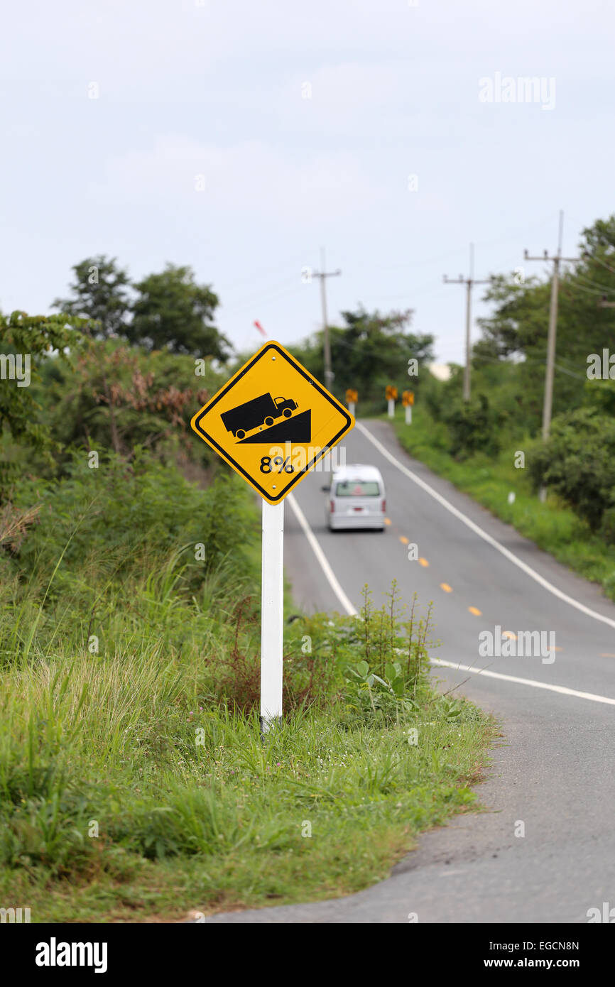 Signposted slope on roadway. Stock Photo