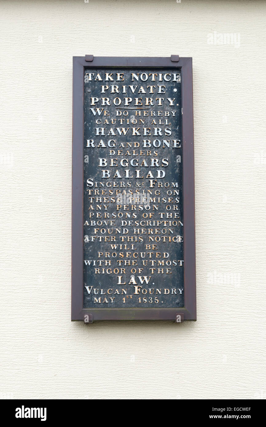 Very old metal sign on the gable end of a row of terrace houses. Stock Photo