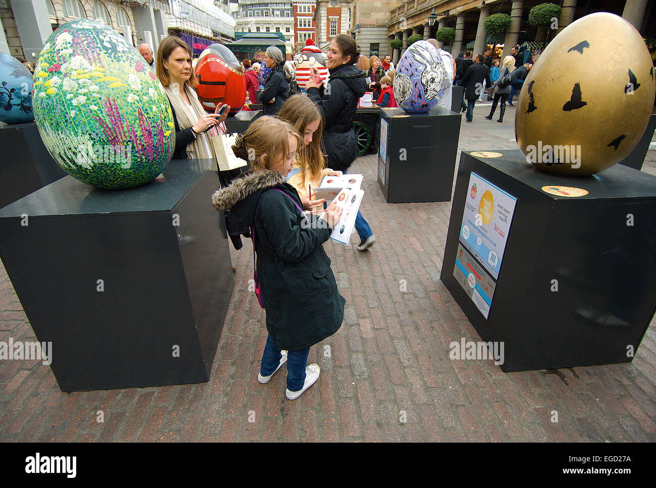 In February 2012, beautiful 2 ½ foot high eggs started appearing round central London, each designed by a different person. At E Stock Photo