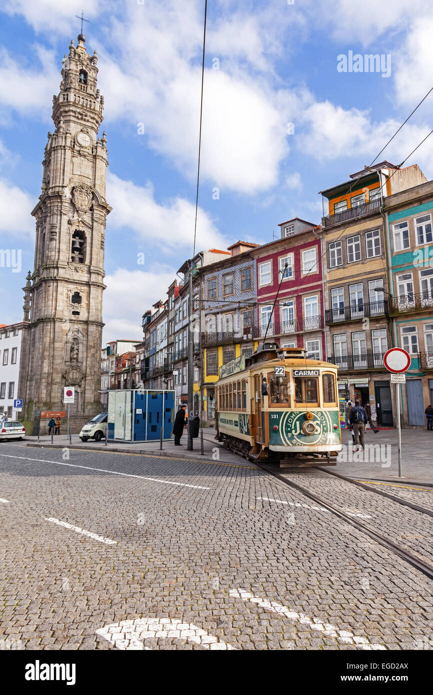Porto, Portugal. The old tram passes by the Clerigos Tower, one of the landmarks and symbols of the city. Stock Photo