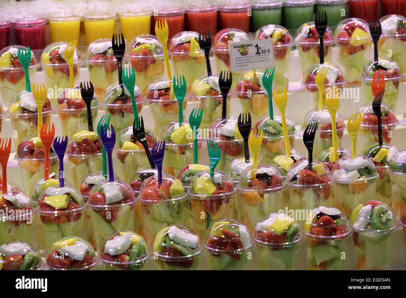Brightly colorful fresh healthy fruit salads for sale food Boqueria Market, La Ramba, Barcelona, Spain Stock Photo
