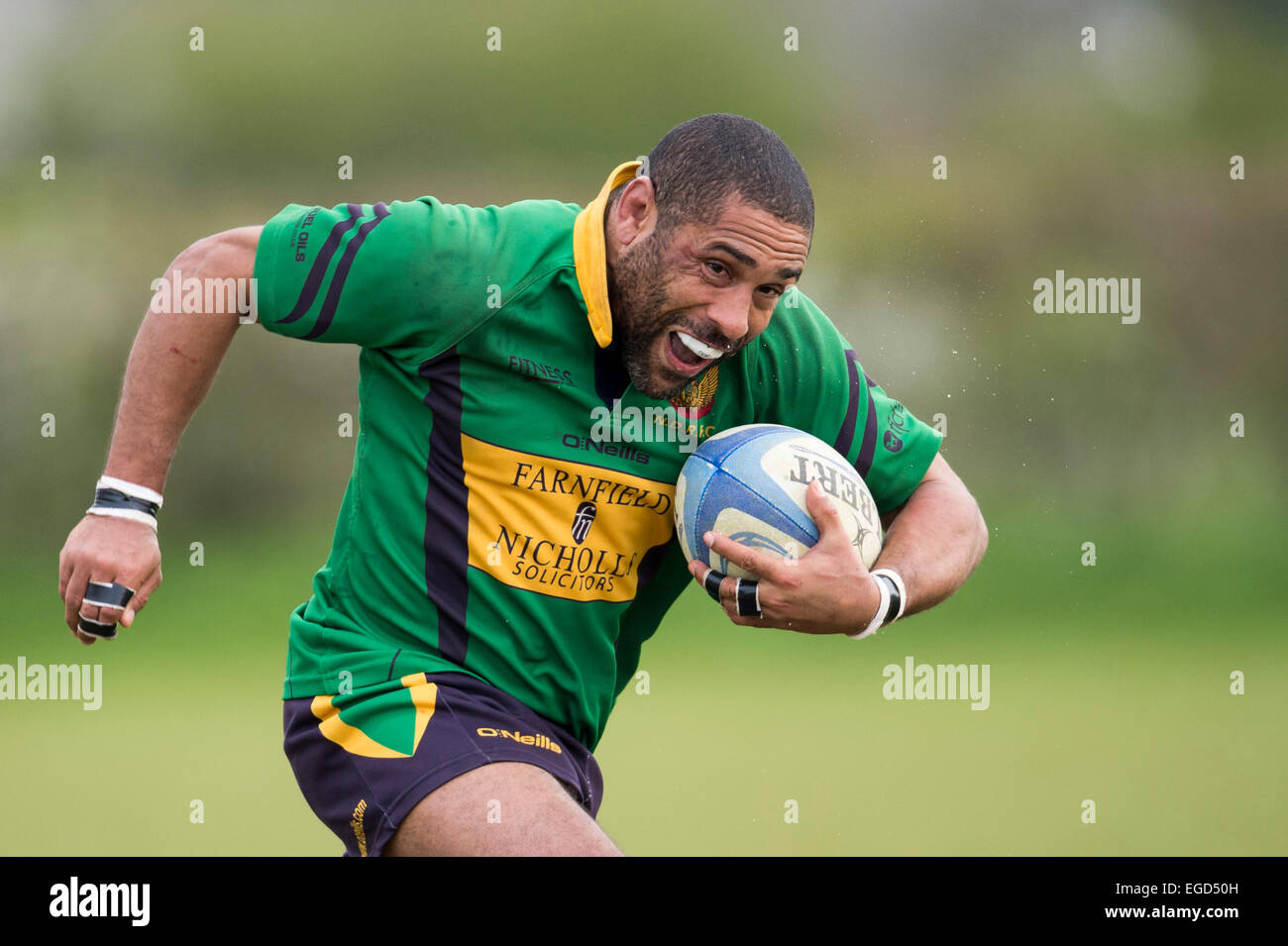 Rugby player in action running with the ball. Stock Photo