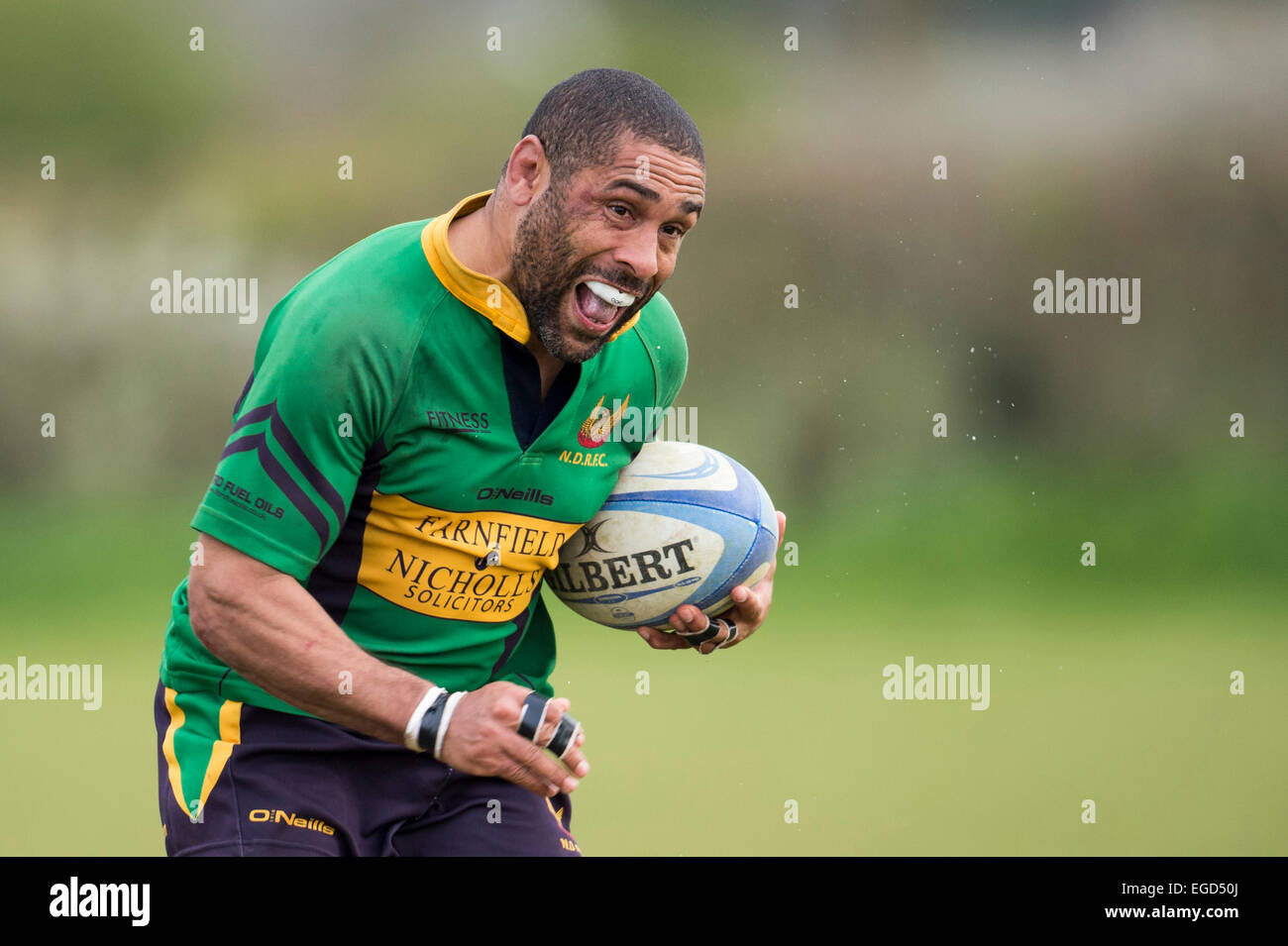 Rugby player in action running with the ball. Stock Photo