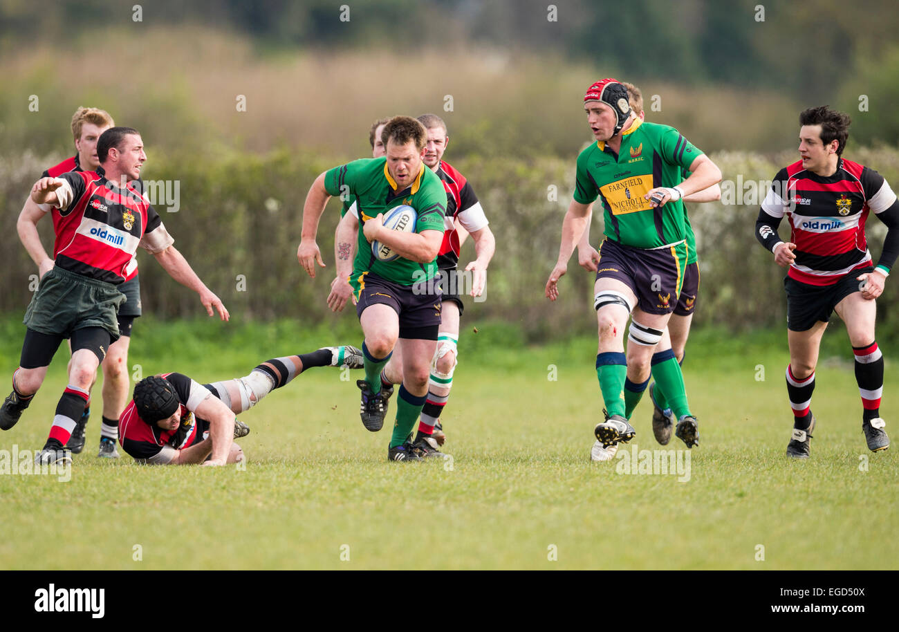 Rugby player in action running with the ball. Stock Photo