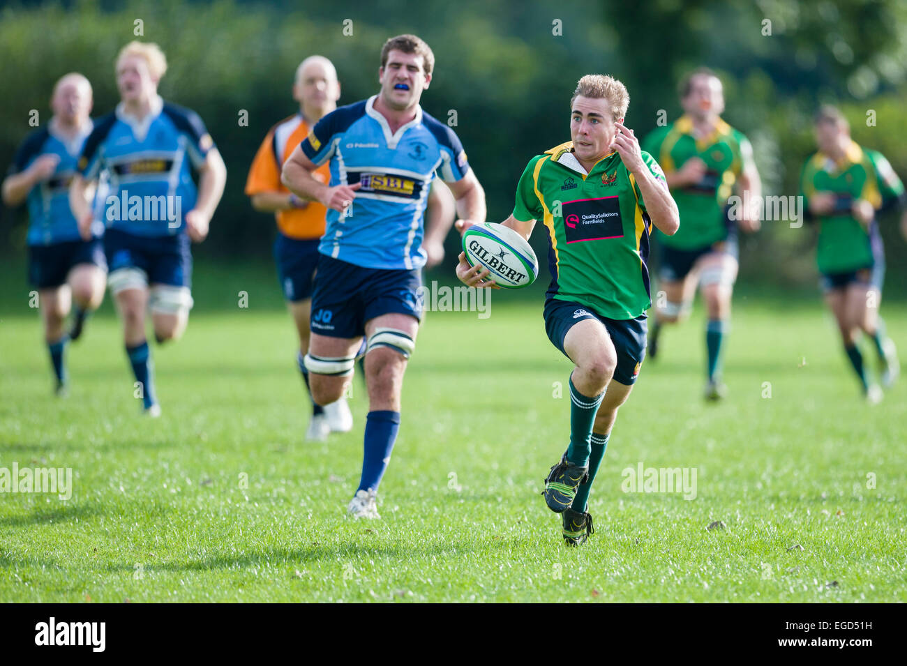 Rugby player in action running with the ball. Stock Photo