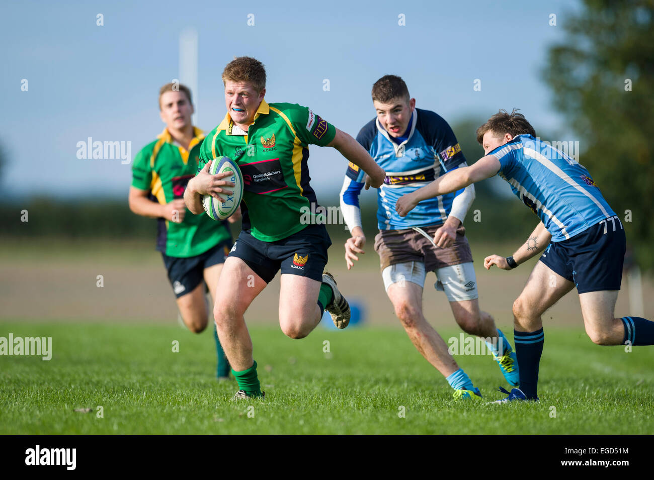 Rugby player in action running with the ball. Stock Photo