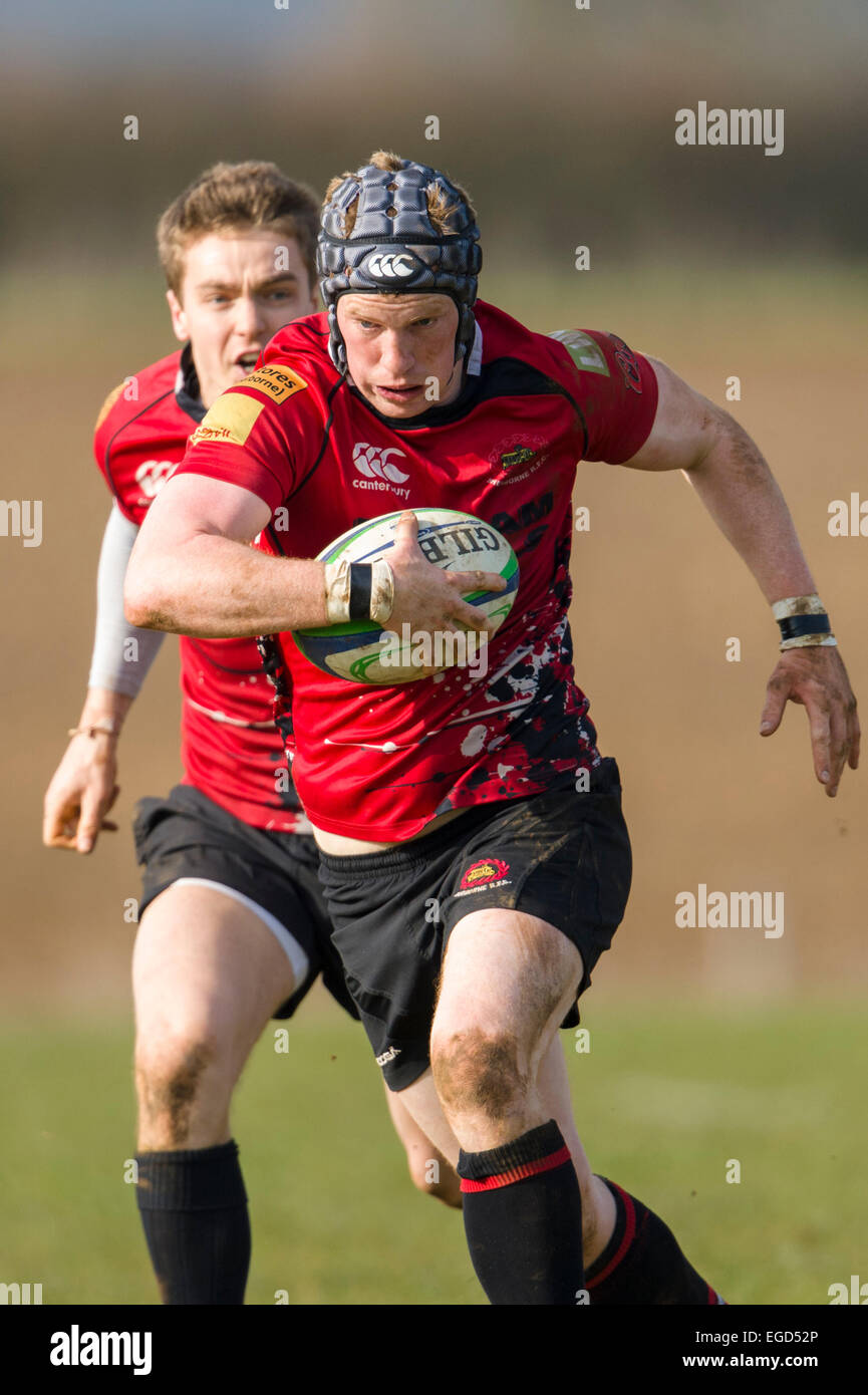 Rugby player in action running with the ball. Stock Photo