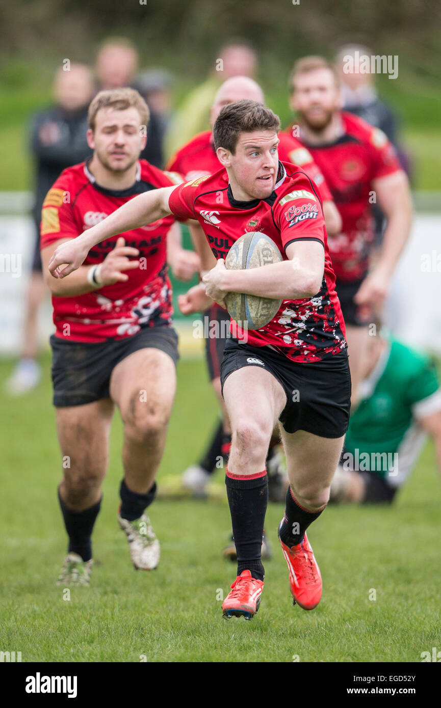 Rugby player in action running with the ball. Stock Photo