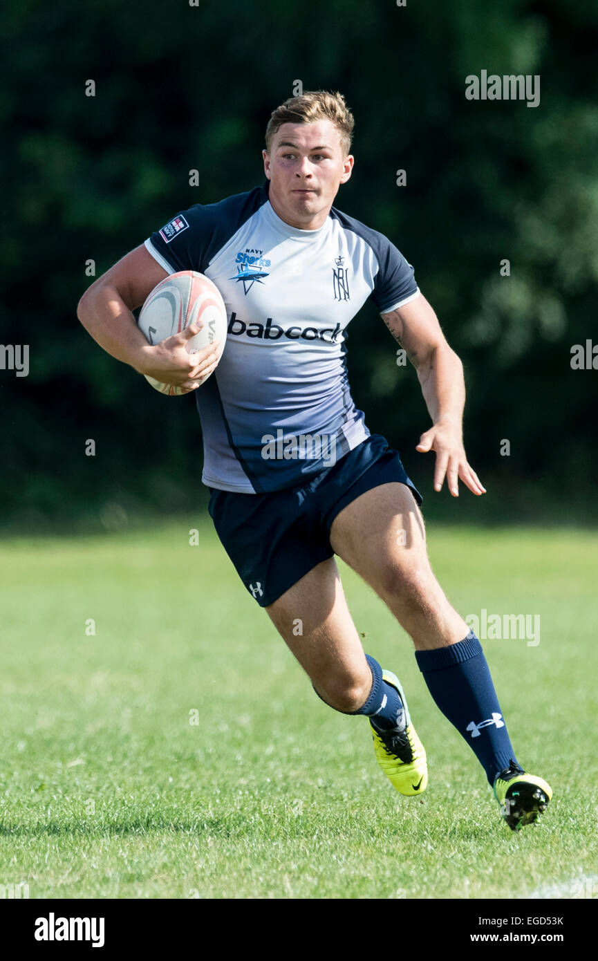 Rugby player in action running with the ball. Stock Photo