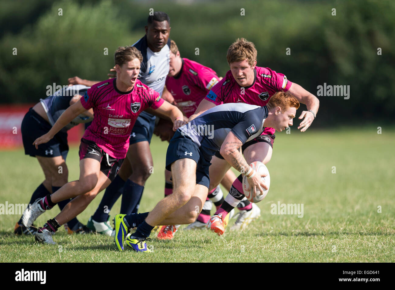 Rugby player in action running with the ball. Stock Photo