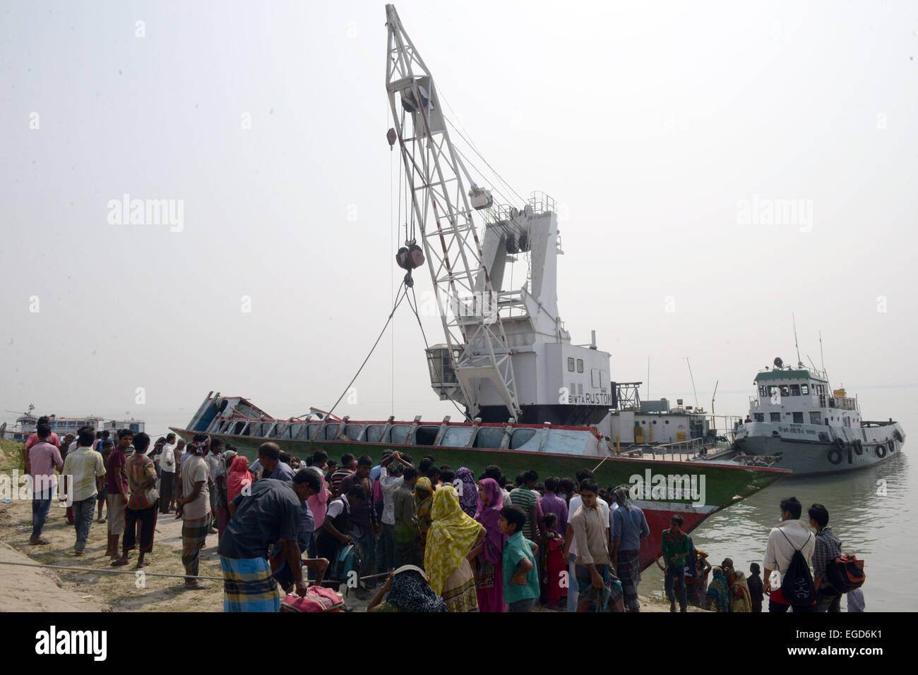Manikganj, Bangladesh. 23rd Feb, 2015. An ill-fated ferry is salvaged a day after it sank into the Padma River in Manikganj district, Bangladesh, Feb. 23, 2015. Death toll in Bangladesh's ferry accident in Bangladesh's western Manikganj district on Sunday rose to 65 as rescuers found 24 more bodies inside the hull of the ferry early Monday, a police officer said. Credit:  Shariful Islam/Xinhua/Alamy Live News Stock Photo