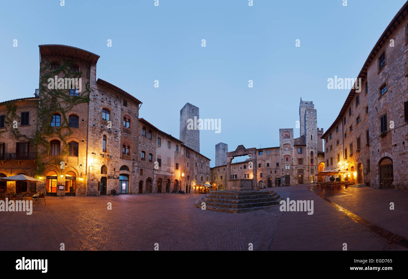 Towers and fountains on Piazza della Cisterna square, San Gimignano ...