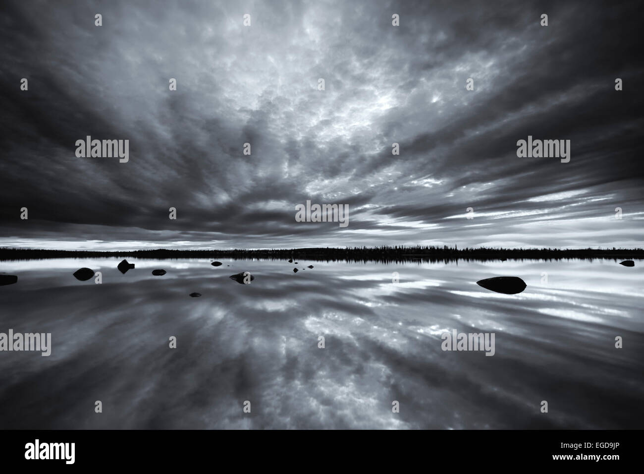 Black and white shot of the lake Muddusluobbal with reflection, Muddus National Park, Lapland, Sweden Stock Photo