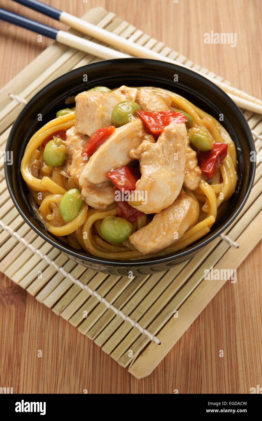 Teriyaki chicken with noodles edamame and red capsicum Stock Photo