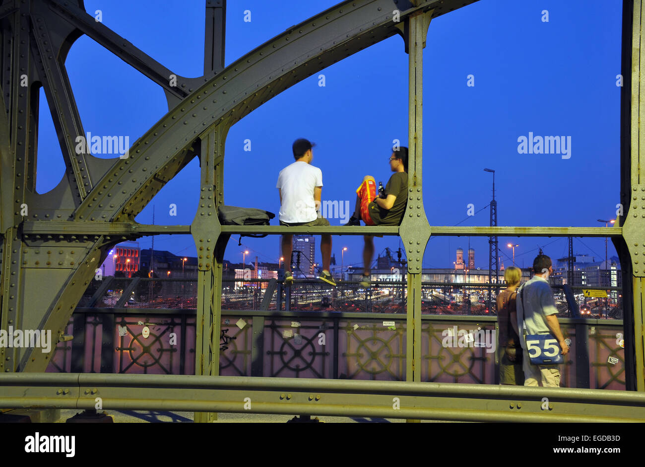 People sitting on the Hacker bridge in the evening, Munich, Bavaria, Germany Stock Photo
