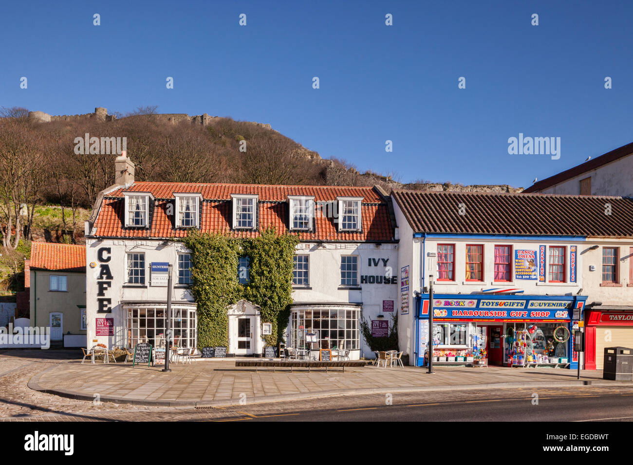Cafe and gift shop along the seafront at Scarborough, North Yorkshire, on a sunny winter day, with Scarborough Castle on the hil Stock Photo