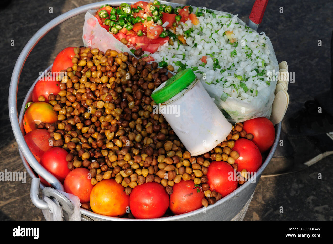 Indian street food of chickpeas tomato and onion in a clean galvanized Bucket at Delhi Railway Station India Stock Photo
