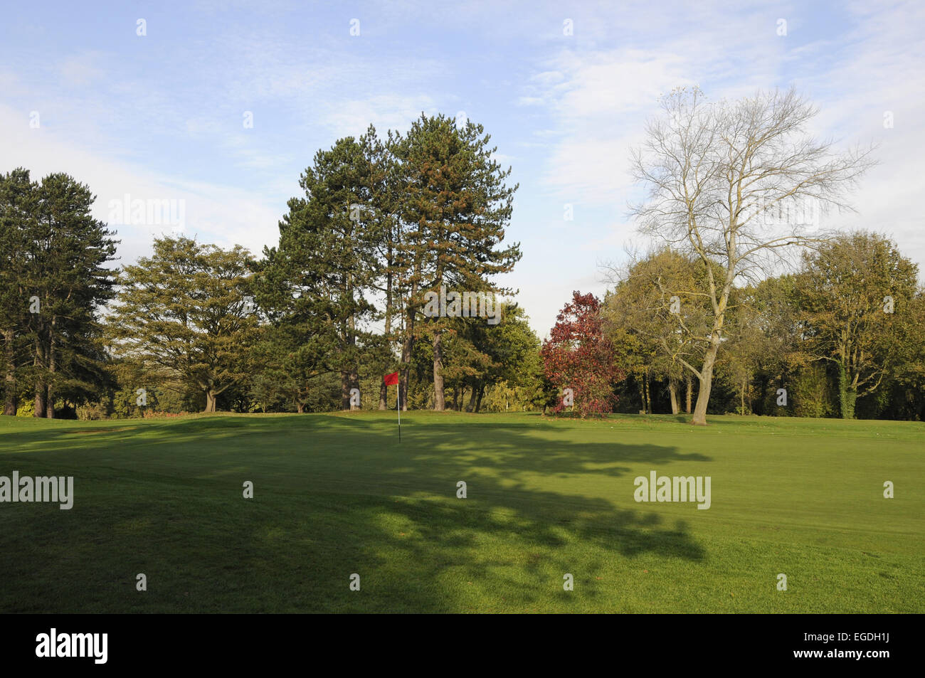 View of the 1st Green with shadows Porters Park Golf Club Radlett Hertfordshire England Stock Photo