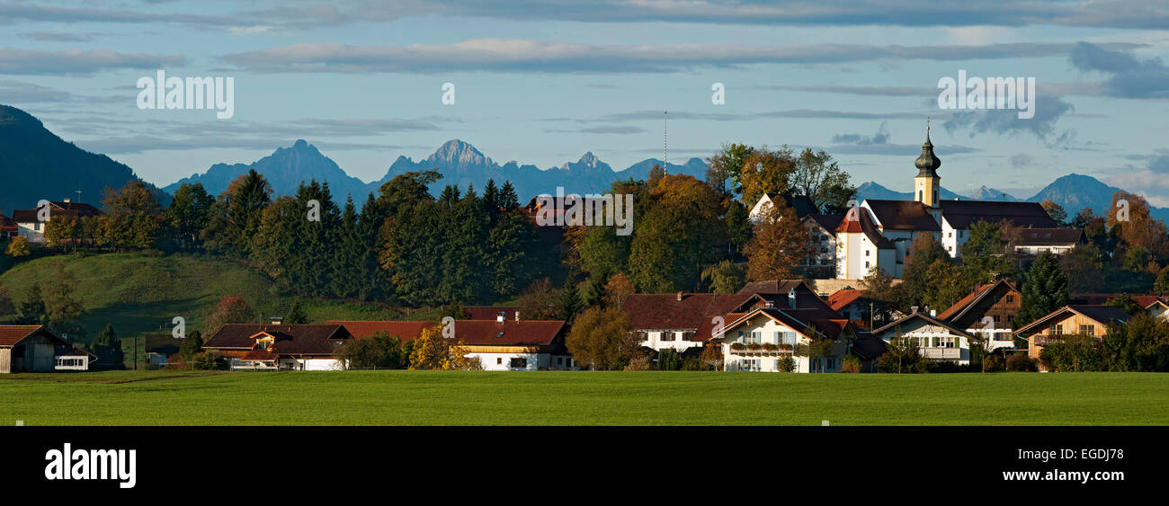 The upper Bavarian village of Wildsteig with the Ammergau Alps in the background, Wildsteig, Weilheim-Schongau, Upper bavaria, Bavaria, Germany Stock Photo