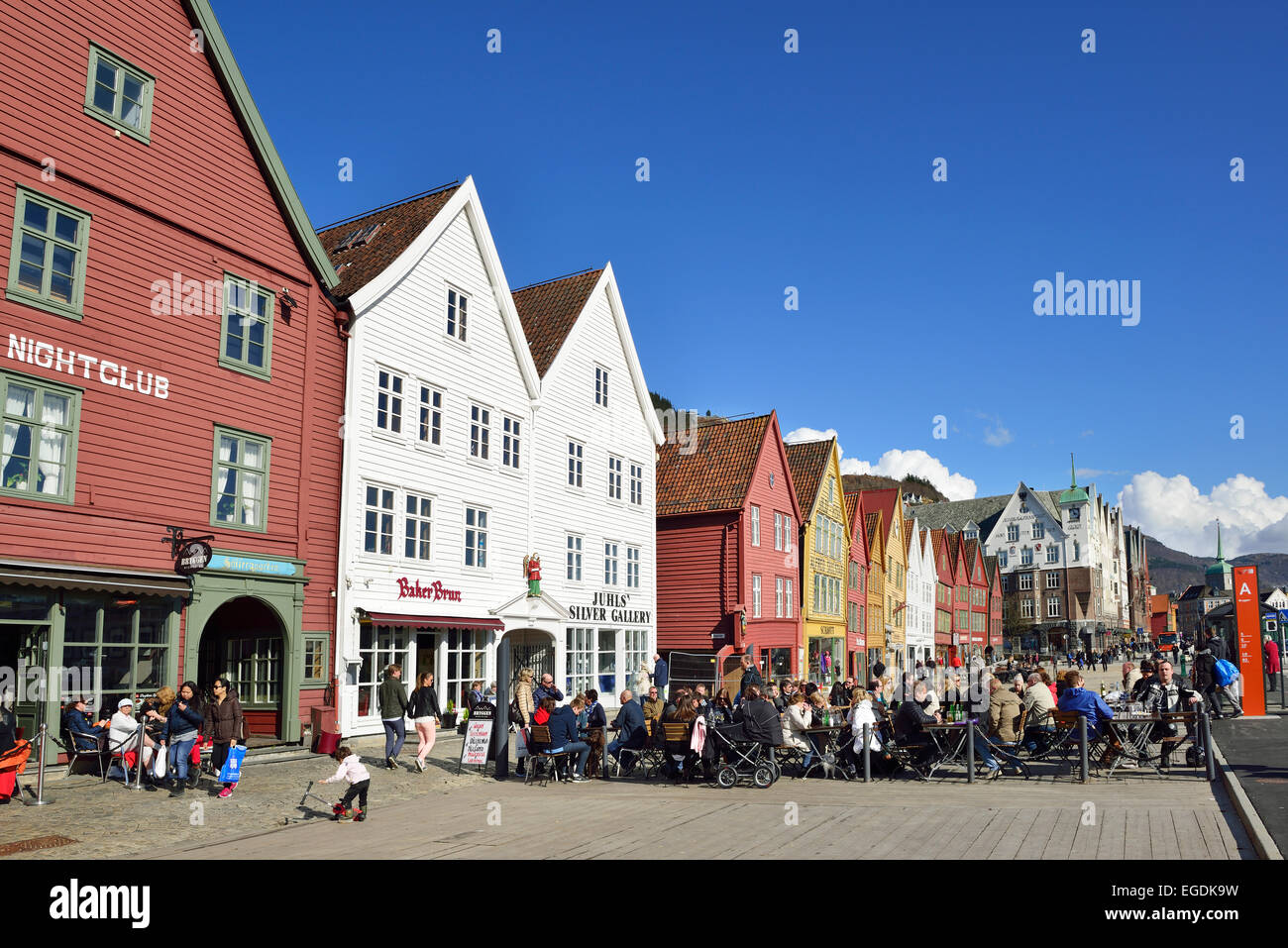 Persons sitting in a cafe, Hanseatic buildings in the background, Bryggen, UNESCO World Heritage Site Bryggen, Bergen, Hordaland, Norway Stock Photo
