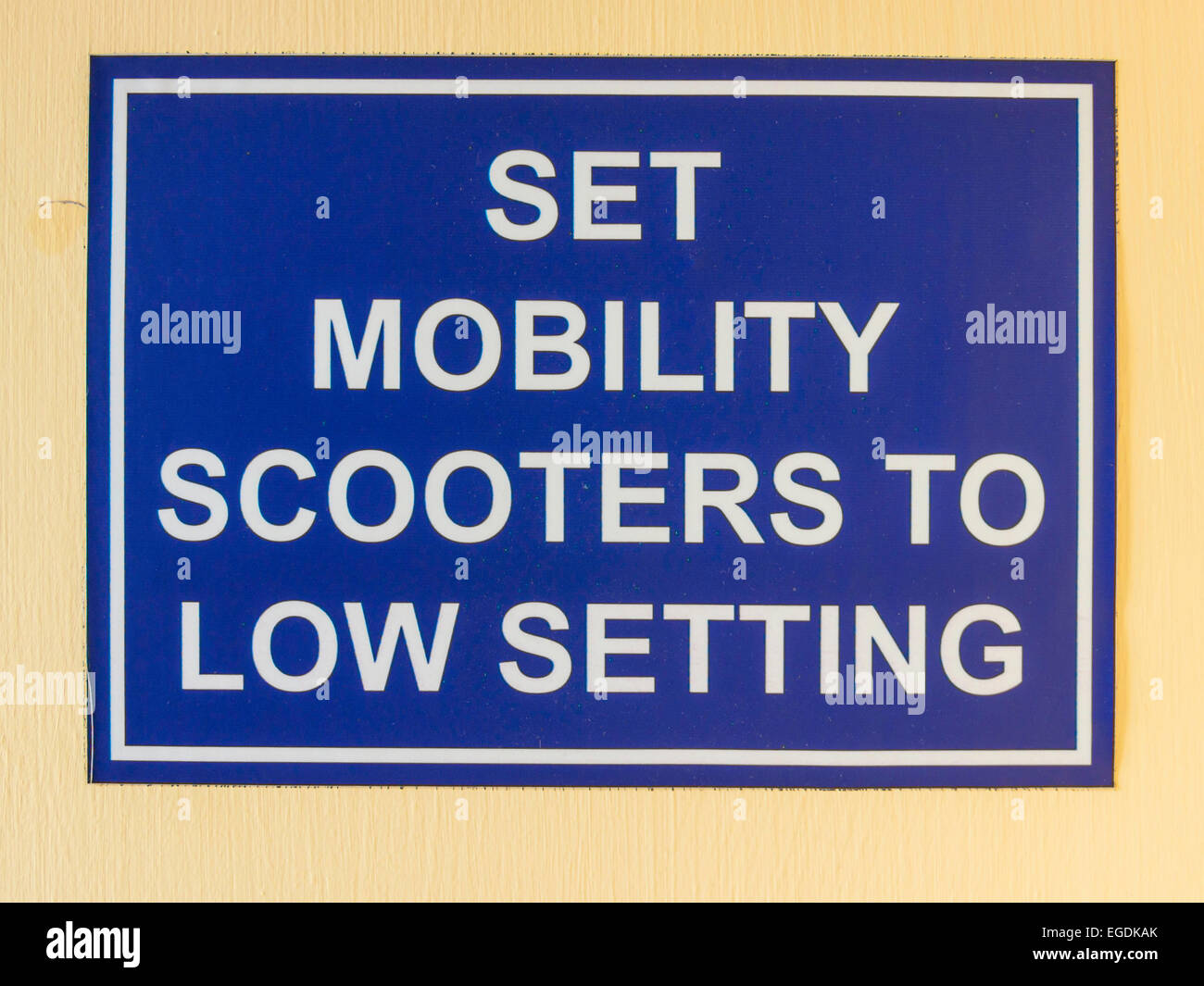 Warning sign notice at a Public Library Entrance: Set Mobility Scooters to Low Setting Stock Photo