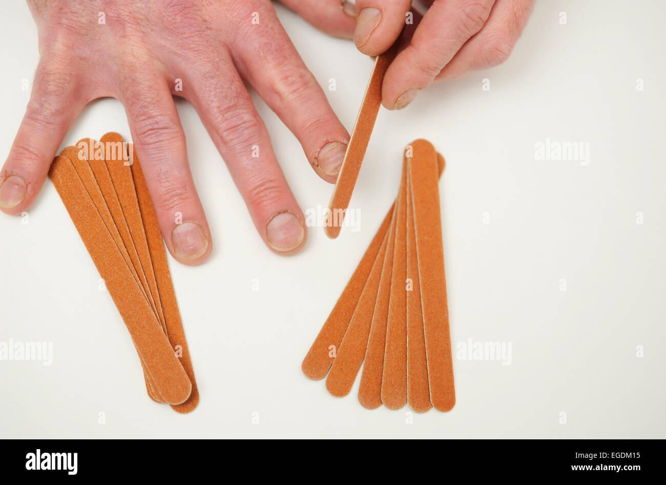 Man filing his nails Stock Photo