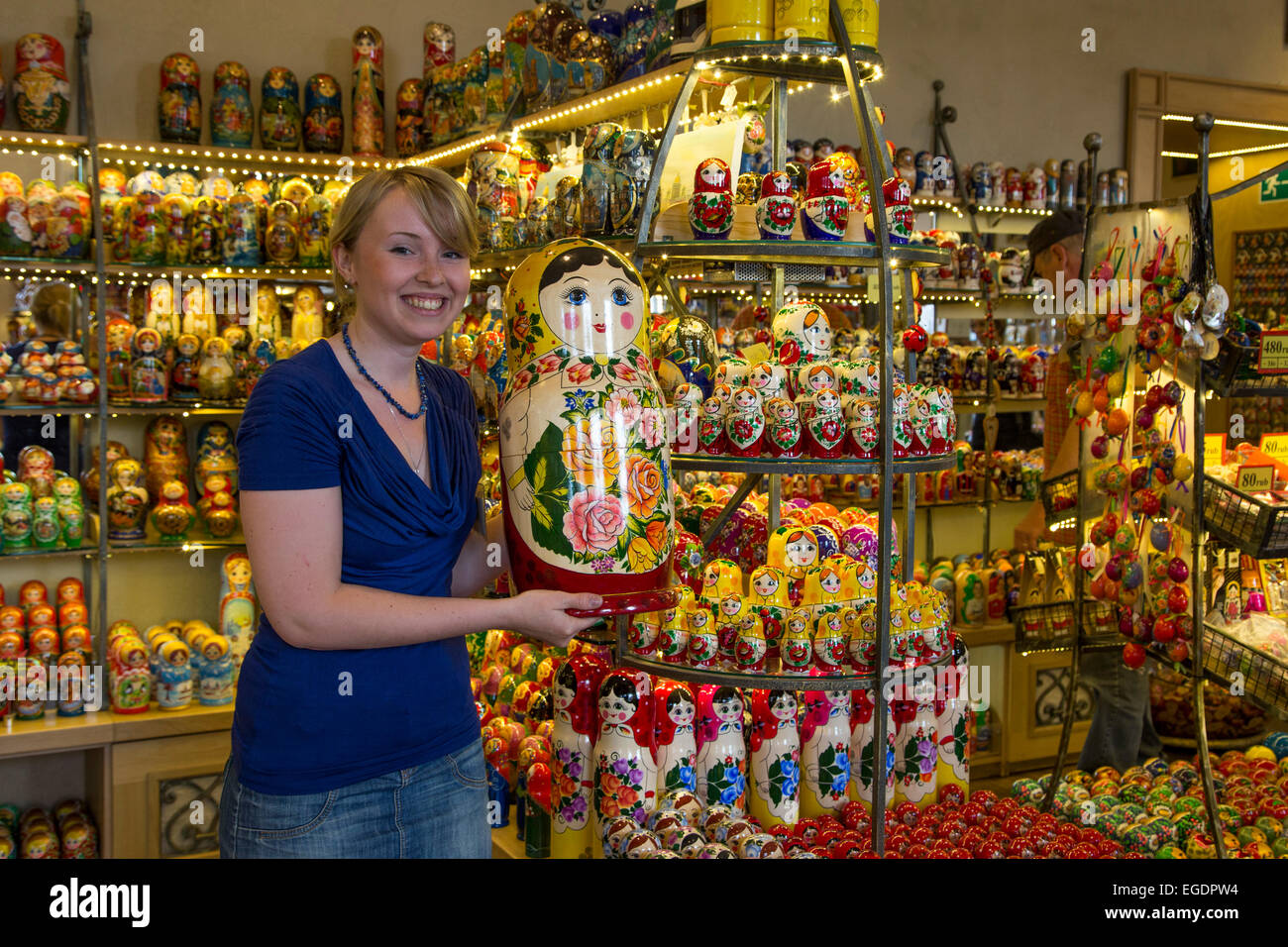 Young woman holding a giant Matryoshka doll for sale in a souvenir shop, St. Petersburg, Russia, Europe Stock Photo