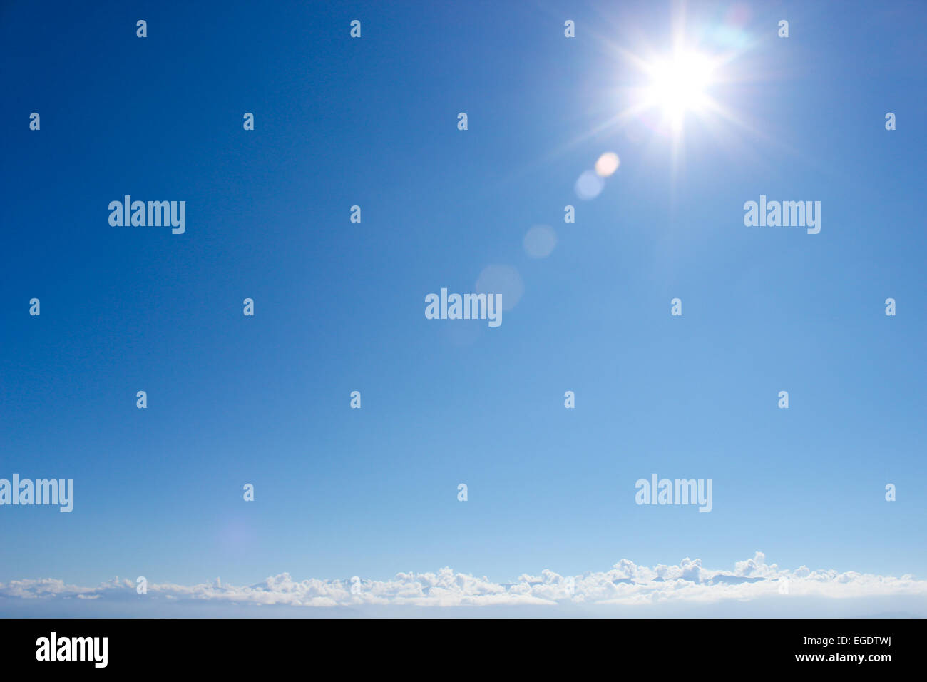 clear blue sky with sun and clouds Stock Photo