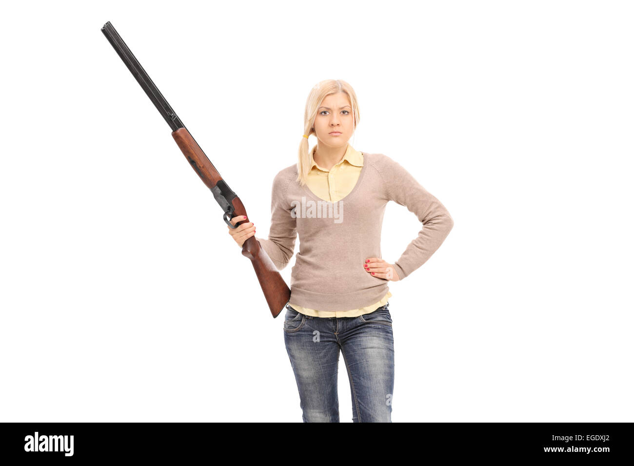 Dangerous girl holding a shotgun isolated on white background Stock Photo