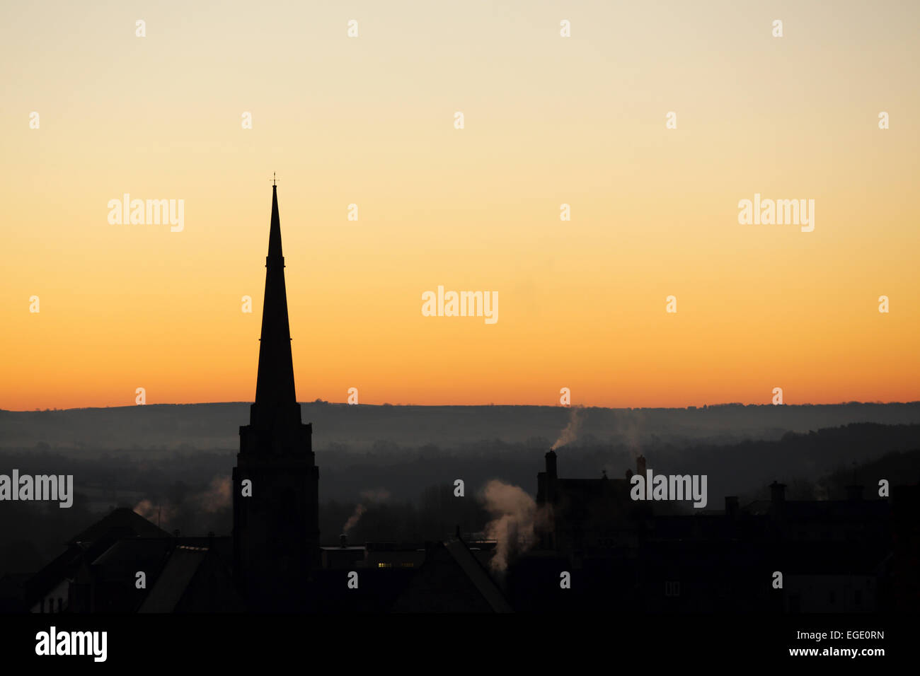 Spire of St Nicholas Church silhouetted against a golden sky in Durham City, England. Stock Photo