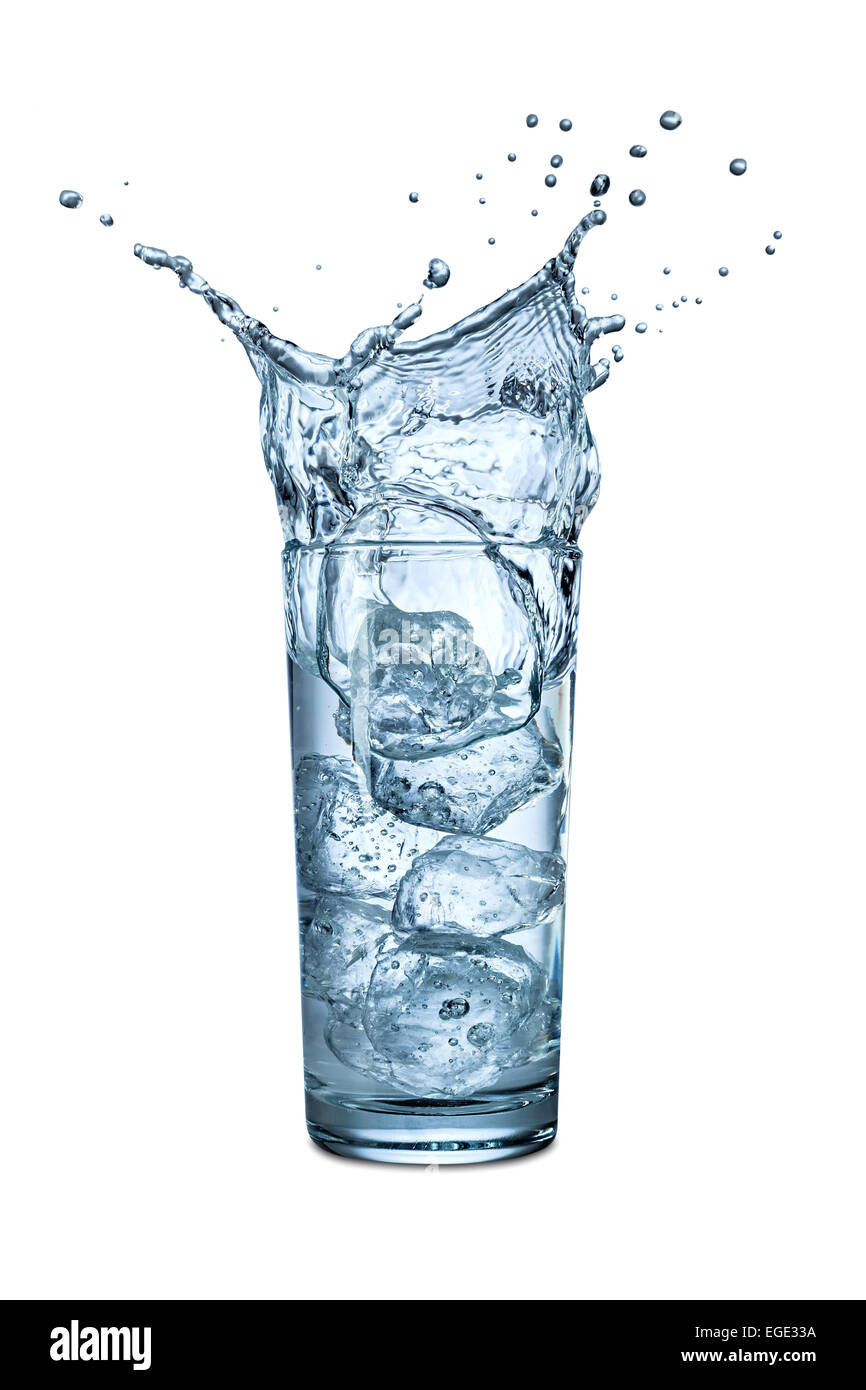 ice splashes into glass of water Stock Photo