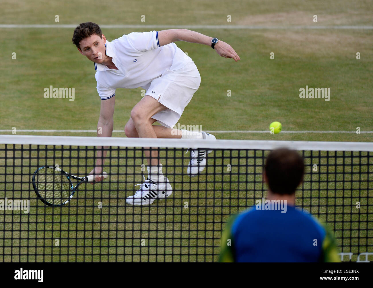 Actor Eddie Redmayne plays tennis during a charity match at Queen's Club in London 2013. Redmayne recently won a Oscar in 2015. Stock Photo