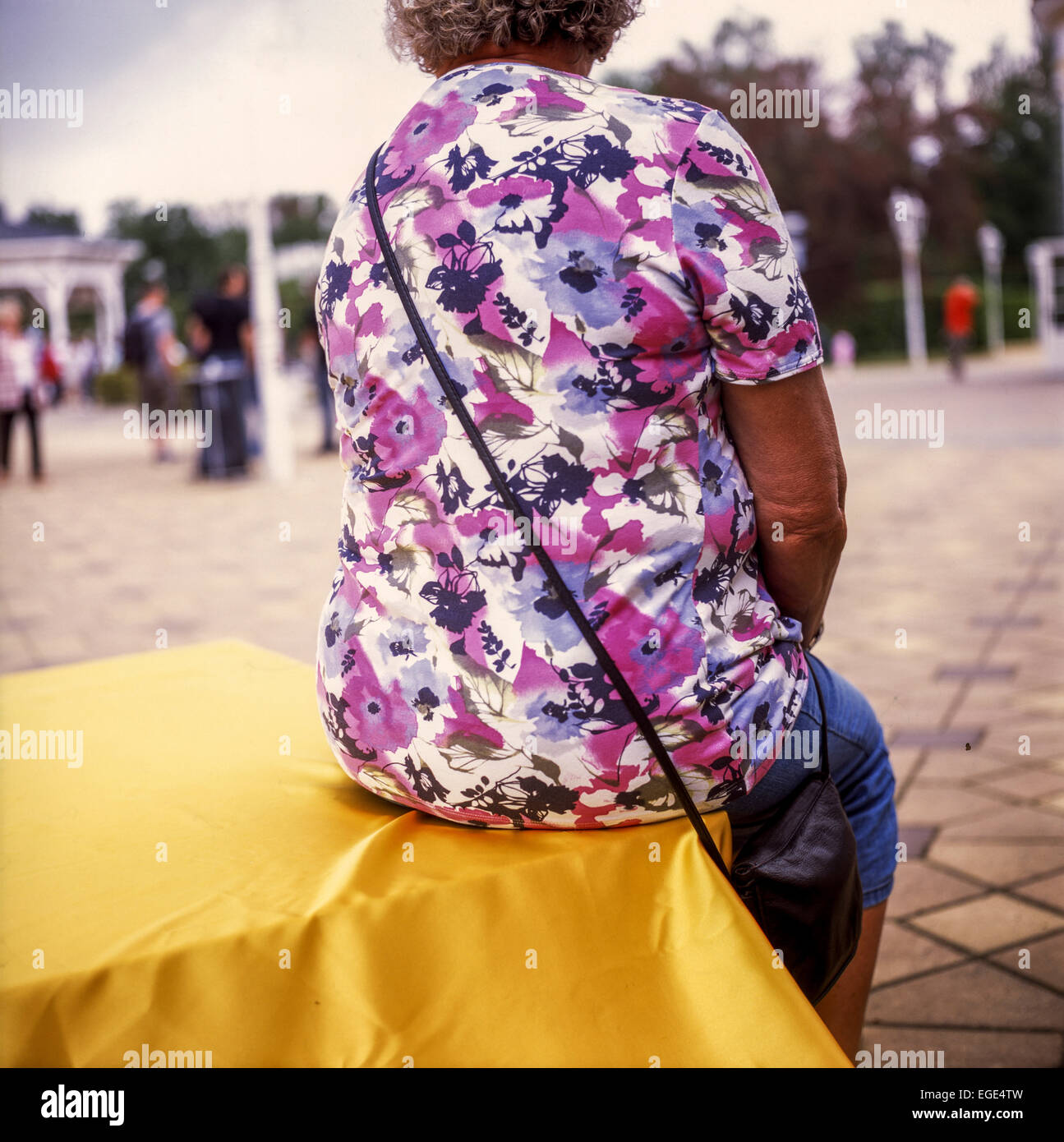 Elderly woman in a flowery dress, floral model Stock Photo